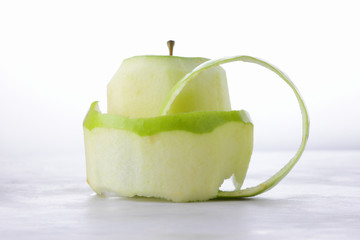 Green peeled apple, apple skin, fruit, healthy food, yak on a light background for the designer, vegetarian food, apple pop art, minimalism, isolated