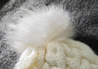 Handmade white pompon on top of the hat close-up