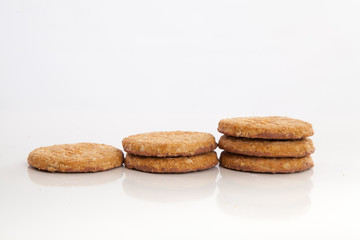 Fototapeta na wymiar piles of round cookies on studio white background