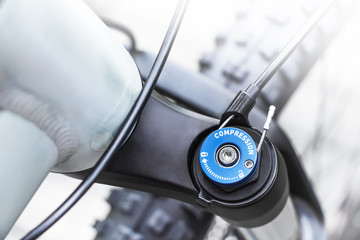 Mountain bike wheel, shock absorber and gear detail, close up shot of top cap of mountainbike front...