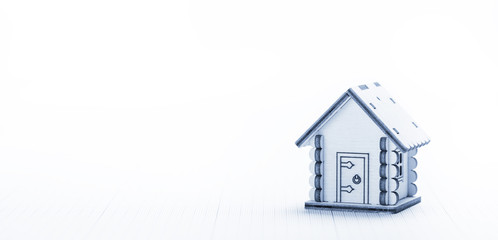 Wooden model of small house on plotting paper, closeup