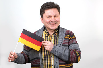 Adult man with the flag of Germany in his hands. An ordinary german man.
