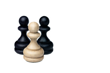 White chess pawn and two black pawns behind on the white background. Boss with his team. Leader.