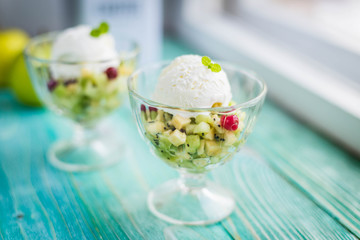 fruit salad with ice cream on a blue background