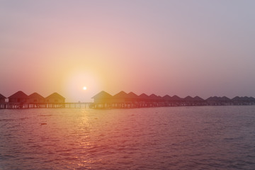 Sunset at Maldives beach, luxury water lodges