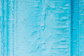 Old wooden painted light blue rustic background with peeling paint. Painted chipped and texture of the wooden surface with oil paint. Damaged texture or background