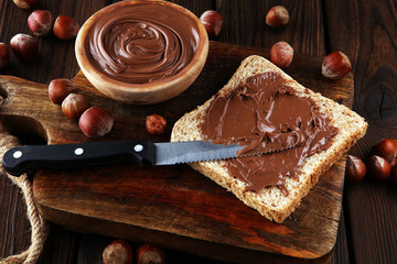 Homemade hazelnut spread with toast and in wooden bowl for breakfast. Hazelnut Nougat cream