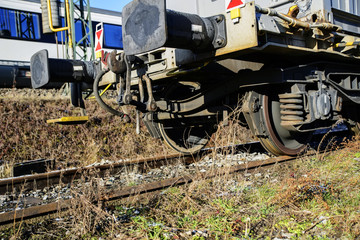Naklejka premium Metal wheels of a railway car standing on rails.