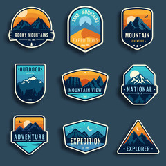 Set of nine mountain travel emblems. Camping outdoor adventure emblems, badges and logo patches. Mountain tourism, hiking. Forest camp labels in vintage style - obrazy, fototapety, plakaty