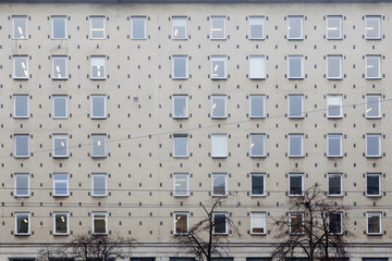 the he facade of a gray office building in Warsaw in the Soviet period