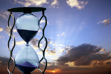 hourglass on the background of sunset.