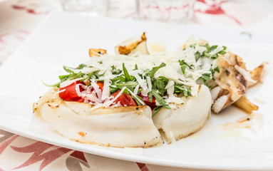Cuttlefish with tomato, salad and Parmigiano cheese