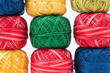 Three rows of colored sewing threads as background. Colorful wallpaper or cover