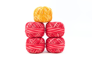 Five sewing threads in a row on a white background. Red and yellow threads