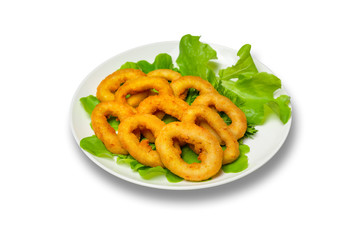 Onion rings with lettuce on a plate on a white background