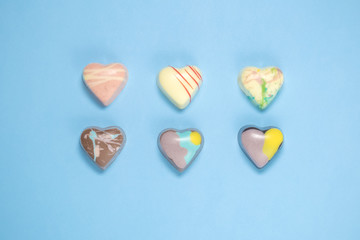 Obraz premium Belgian chocolate hearts on blue background