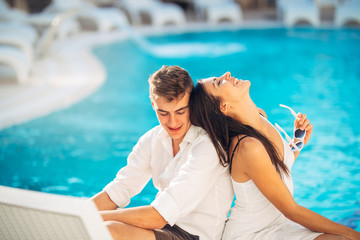 Cheerful happy couple enjoying spa vacation in luxurious summer resort.Honeymoon trip.Anniversary  celebration.Boyfriend and girlfriend having fun.Emotional connection.Engagement.Newlyweds