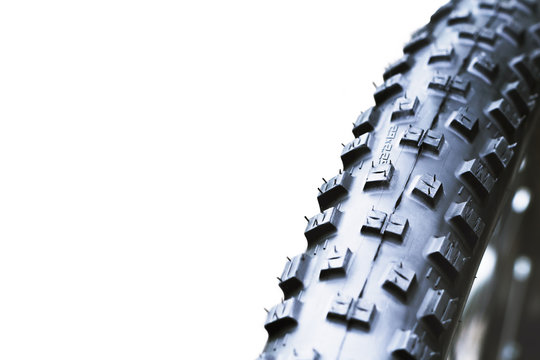 New And Clean Black Mountain Bike Rear Wheel Detail And 29 X 2,2 Tire Close Up, Abstract With White Background