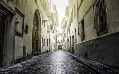 Fototapeta na wymiar Small old street in Florence (Firenze) after the rain