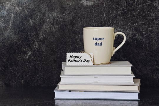 Father's day composition. Books with cup of tea on top. Father's day concept 