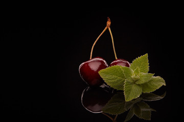 Sweet cherry berries and branch of mint. © Dmitriy Melnikov