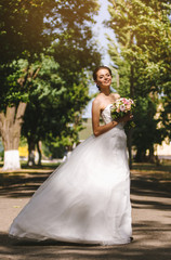 Beautiful brunette bride portrait in summer park