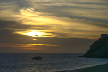 Naklejka na ściany i meble Sunset on the Pacific Ocean on the Baha peninsula at Cabo San Lucas, Mexico