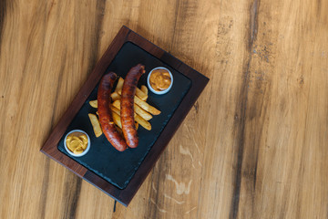 Home made sausage on the wooden table .