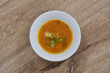 Chickpeas soup with vegetable on a wooden table