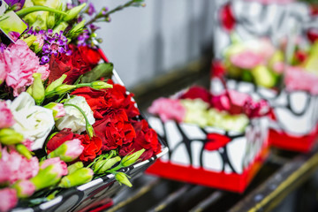 Beautiful bouquet of fresh flowers in boxes. Florist service concept. Retail and gross cut flower store concept. Flowermarket background