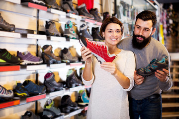 Couple deciding on new sneakers