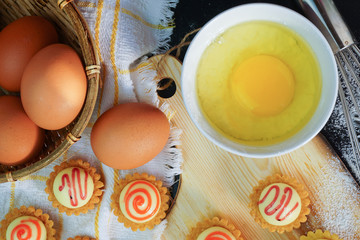 Delicious Egg Tarts On The Wooden Board.