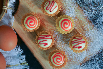 Egg tarts on the wooden board.