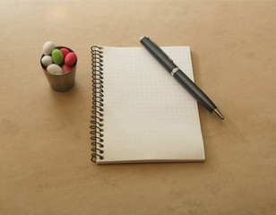 notepad pen and metal wine glasses on a table