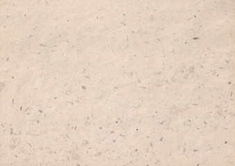 texture of kraft paper sheet with dark brown grain shavings