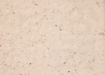 texture of kraft paper sheet with dark brown grain shavings