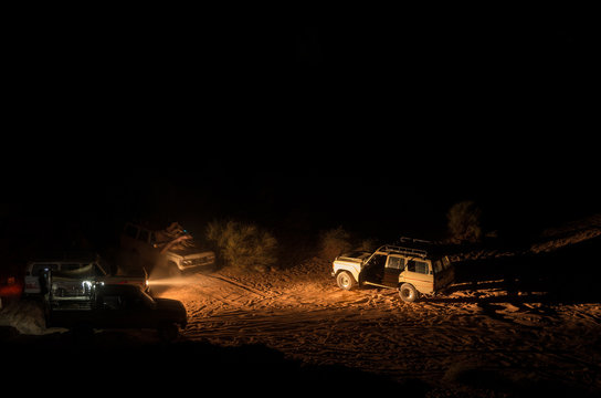 4x4 vehicles in the dark of the desert