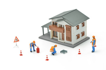 Miniature people Construction worker repair A model house model  using as background real estate concept and repair concept with copy space for your text or design.
