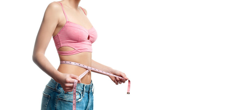 Woman is measuring waist after weight loss on white background