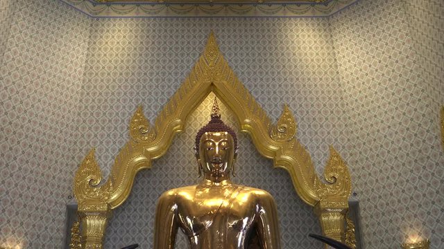 close up tilt down shot of the golden buddha at wat traimit temple in bangkok, thailand