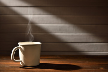 Cup of coffee with smoke on wooden background, This image with no smoke is available