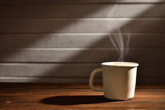 Cup of coffee with smoke on wooden background, This image with no smoke is available