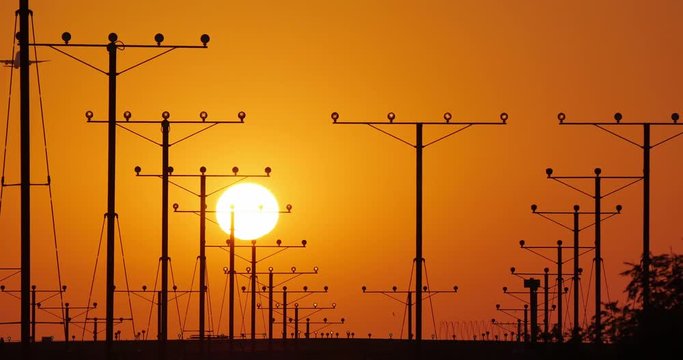 Small private business airplane jet plane landing in airport at sunset. 4K UHD.