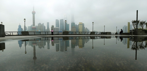 view of building of Pudong  in Shanghai, China, with refection on water 