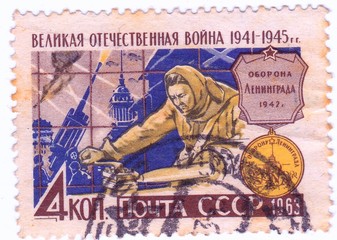 USSR - CIRCA 1963: A stamp printed in the USSR, shows woman working on a lathe.