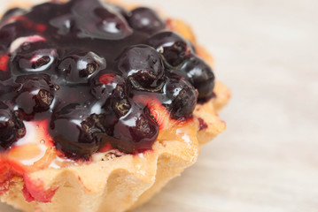 Sweet Dessert Berry Tarttlet or Basket with copy Space for Text. Gray wooden Table.