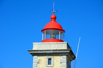 Top part of the lighthouse with its red painted top, Ponta da Piedade, Algarve, Portugal.
