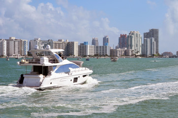 White motor yacht cruising the florida intra-coastal waterway headed towards Biscayne Bay with...