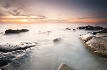 Fototapeta premium long expose sunset seascape with waves trails. image contain soft focus due to long expose.