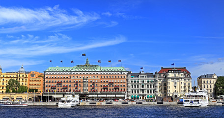 Stockholm, Sweden - Norrmalm district view from Old town quarter Gamla Stan - Baltic sea harbor piers and most prominent shoreline residences - obrazy, fototapety, plakaty
